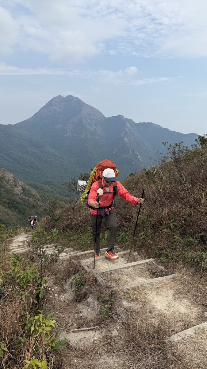 戎琦背负行囊行走在山路上